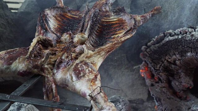 rustic lamb barbecue bbq over open fire in Patagonia, Argentina, South America. Asado is a Gaucho traditon with cooking on open flame