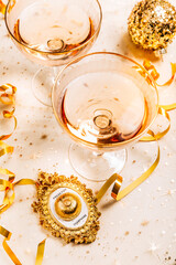 Two glasses of sparkling wine on festive table for New Year, party or carnival.  Bell push button for champagne
