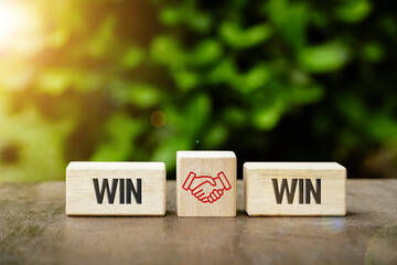 Wooden cube with the word win win with handshake icon, Win win situation in business strategy. 