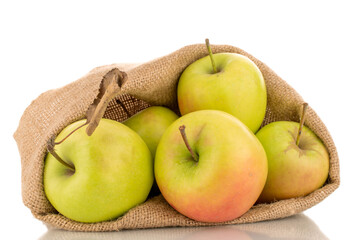 Several green sweet apples with jute sack, macro isolated on white background.