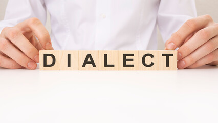 Dialect word on wooden block, white background