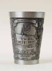 Traditional German vintage pewter wine glass with a bas-relief depicting the city council building in Gartringen - 556173887