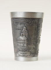 Traditional German vintage pewter wine glass with a bas-relief depicting the abbey church and city council building in the city of Herrenberg - 556173893