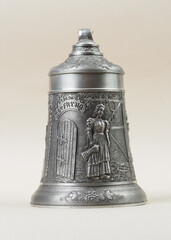 Traditional German vintage beer pewter wine glass with a bas-relief depicting a woman with a jug in her hand - 556174093