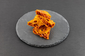Pieces of cracked golden honeycomb made from honey and baking soda