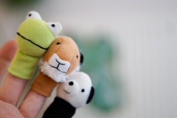 wearing 10 finger puppets. Frog, lion, tiger, panda bear. 