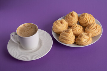 photo cup with coffee and meringue cakes on a plate
