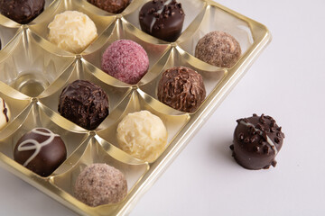 photo of round chocolates lying in a box