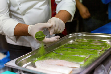 The chef cooking sole. Marinating fish with a mixture of 5 spices.