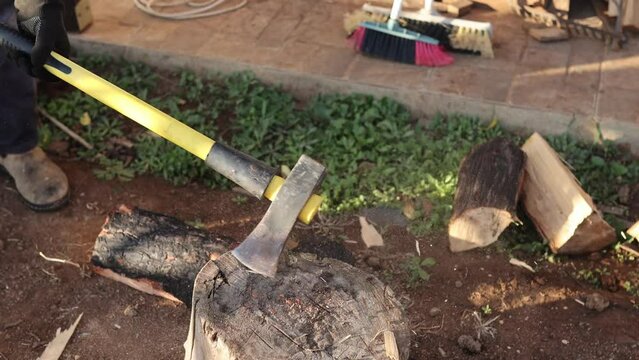 Man chopping woods with ax in countryside close up. lumber Man cutting woods, winter, cold, firewood