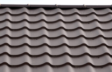 The roof of the house is covered with metal tiles