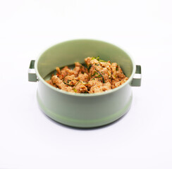 Thai food, ancient larb, in a pinto on a white background
