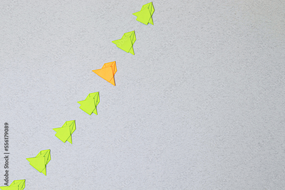 Poster unique paper plane flying up in the sky while the group of failure is falling down.