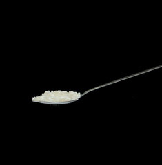 Japanese Rice fall, white grain rices pouring down abstract cloud fly from spoon. Beautiful complete seed rice in air, food object design. Selective focus freeze shot Black background isolated