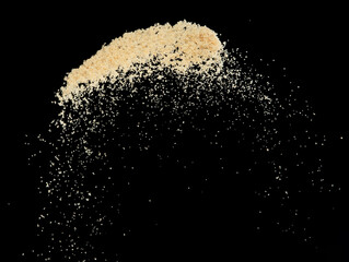 Brown Sugar flying explosion, brown grain sugar explode abstract cloud fly. Beautiful complete seed sugarcane splash in air, food object design. Selective focus freeze shot Black background isolated