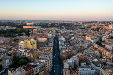 Fototapeta na wymiar Aerial View of a Wide Avenue Looking Towards the Coliseum and Forum in Rome at Sunrise
