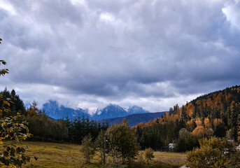 Autumn view of snowy mountains.
Autumnal hills and snowy mountain ridge.
Bucegi natural park