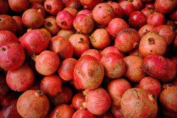Pomegranate garnet fruit  background. Fresh organic garnets. Natural pomegranate heap closeup top view