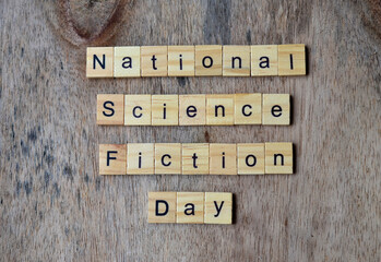 National science fiction day text on wooden square, holiday quotes
