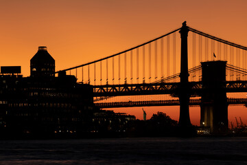 East River view at dusk towards Manhattan and Brooklyn Bridge. 