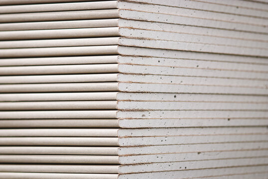 Drywall standard gypsum panels, wallboards plasterboard stacked in hardware store closeup