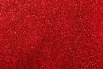 Background with sparkles. Backdrop with glitter. Shiny textured surface. Strong red