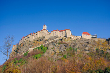 Fototapeta premium The medieval Riegersburg Castle on top of a dormant volcano, surrounded by beautiful autumn landscape, famous tourist attraction in Styria region, Austria