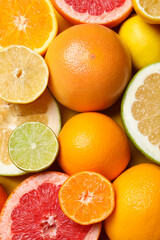 Different ripe citrus fruits as background, top view