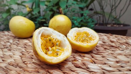 Ripe passion fruit laid out on a straw mat.