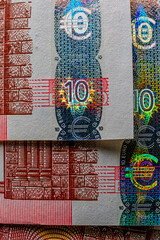 closeup of European currency seal, with hologram and other security features visible. seal designed to be tamper-proof. hologram extra layer of authenticity, as reflects light in distinctive pattern - 556192860