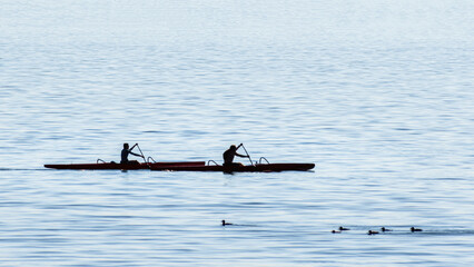 People are kayaking in the ocean
