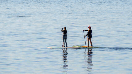 People are enjoying stand up paddle boarding