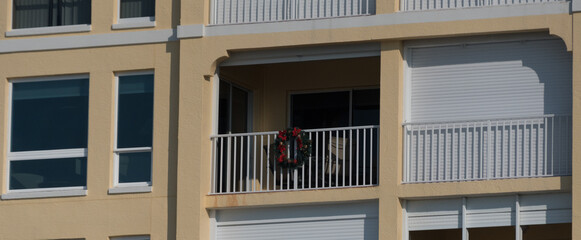 Alone Christmas wreath on balcony of resort building near Indian Shores