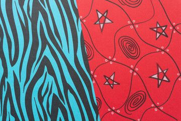 esoteric background with striped blue and black paper and red paper with squares, stars, and swirls