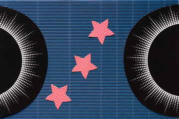 printed circle designs and red stars with dots on dark blue corrugated paper