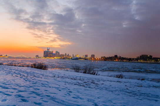View of Downtown Detroit at sunset with the Detroit river frozen over