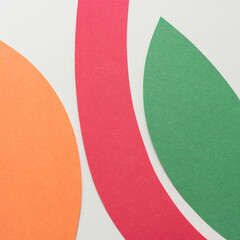 orange red and green paper shapes on blank paper