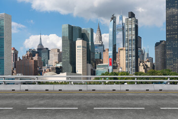 Empty urban asphalt road exterior with city buildings background. New modern highway concrete construction. Concept of way to success. Transportation logistic industry fast delivery. New York. USA.