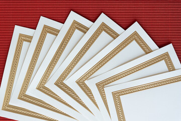 overlapping elegant stationery invitation cards on red corrugated paper