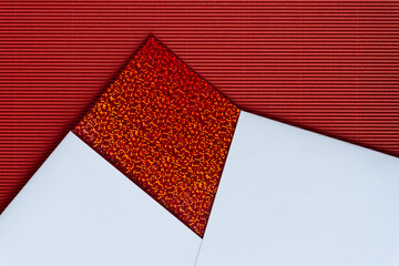 rich paper background featuring red glitter paper, white bristol board, and red corrugated paper