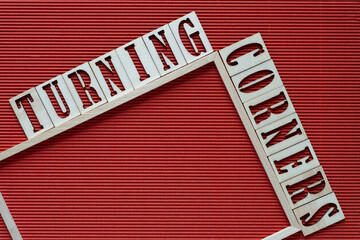 turning corners and wood frame on red corrugated paper