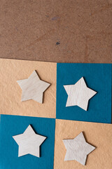 paper squares and wood stars on old board