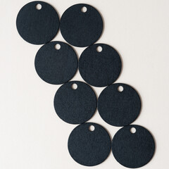 set of black circles made of wood with holes on blank paper