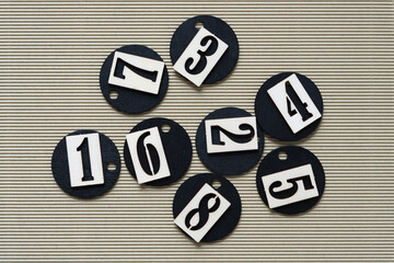 stencil type numbers, black round tags, and corrugated paper