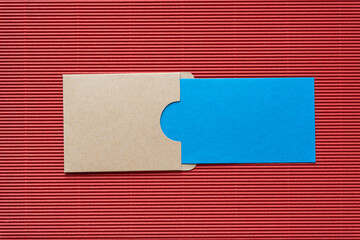 pocket envelope with blue paper card on red corrugated paper