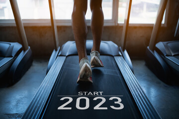 Happy new year 2023,2023 symbolizes the start of the new year. Close up of feet, sportman runner...