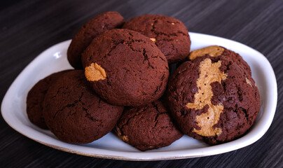 Chocolate cookies with peanut butter on a dark background