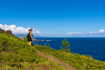 Fototapeta na wymiar Female Hiker on The Ohai Trail Along The Maui Shoreline, Maui, Hawaii, USA