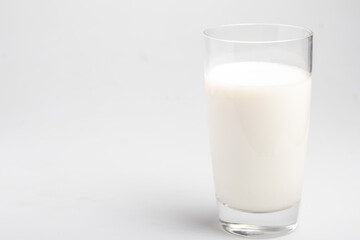 fresh milk in transparent glass on white background