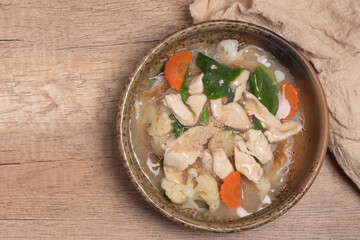Thai Chicken and Gravy with vegetables poured over noodles.Thai food.